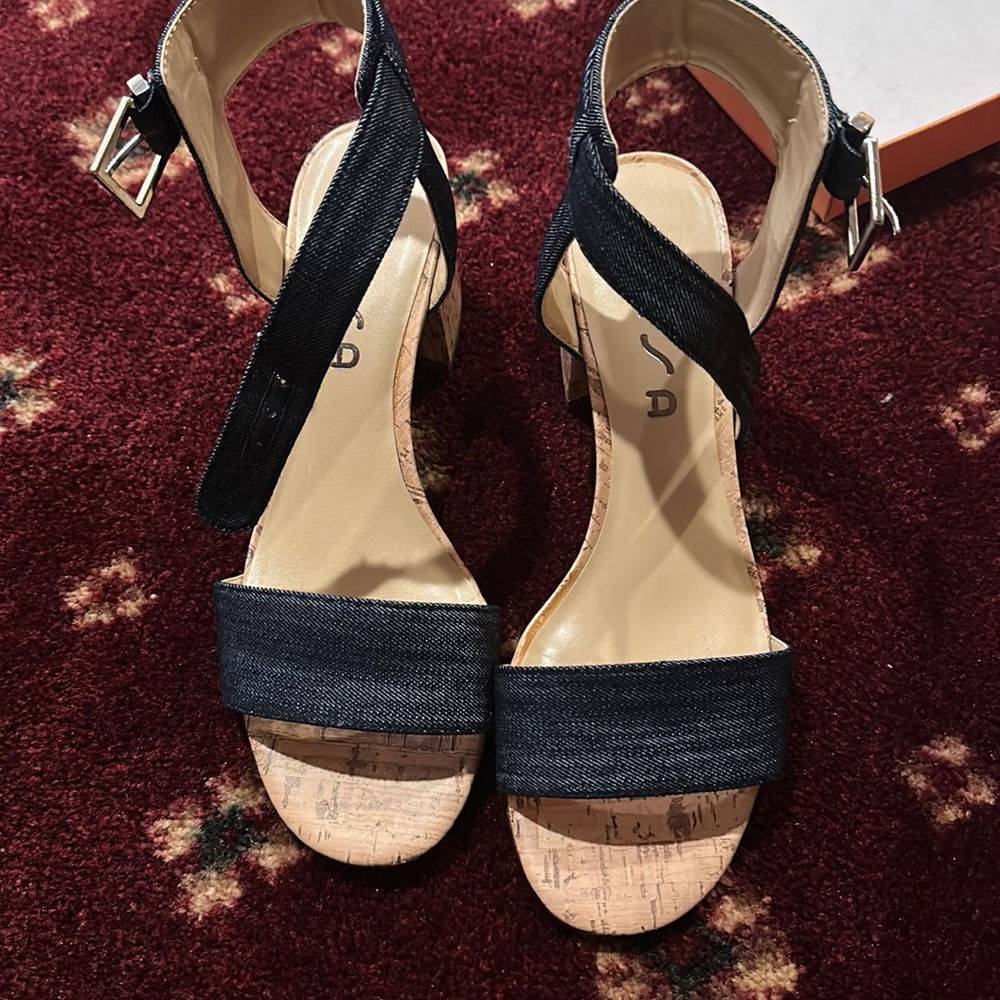 A heeled sandal with denim design and wood design